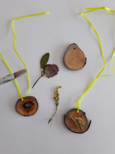 Photo of wood pendants with pressed flowers.